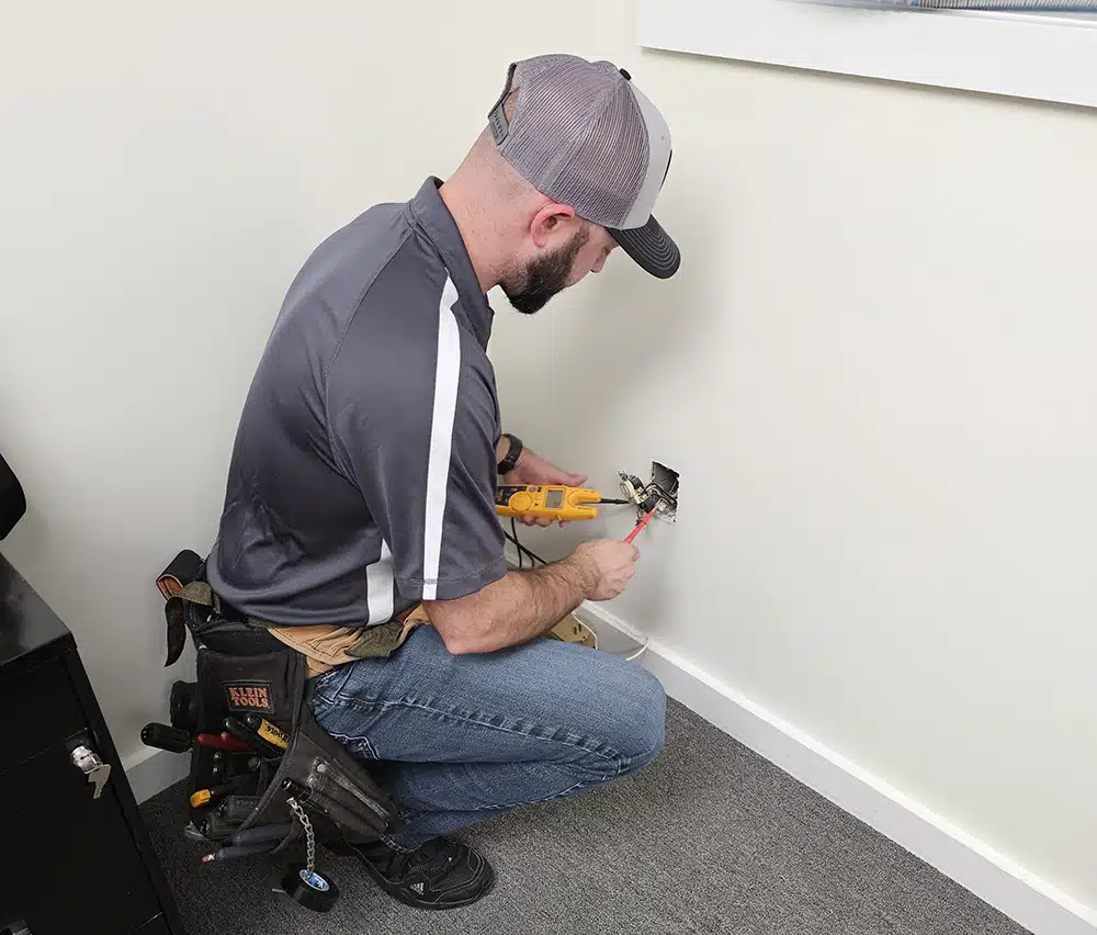 Gabe's electrical technician testing outlet in residential home in Brookfield, CT.